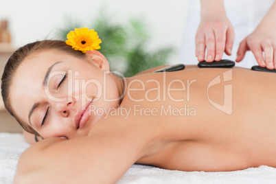 Delighted woman having a hot stone massage