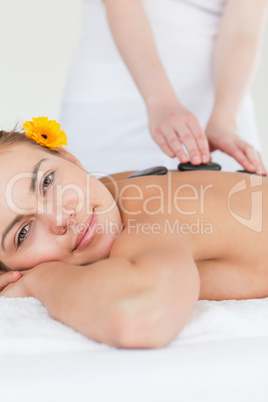 Portrait of a delighted woman having a hot stone massage