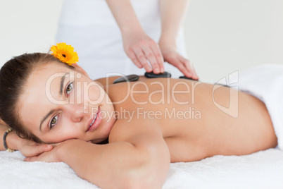 Close up of a delighted woman having a hot stone massage