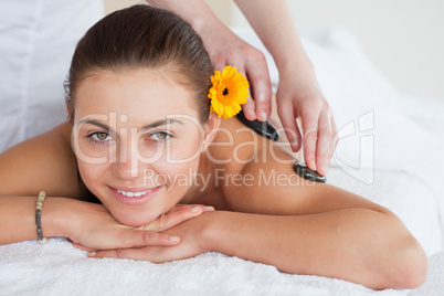 Smiling woman enjoying a hot stone massage