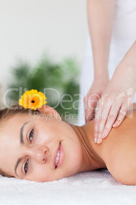 Portrait of a beautiful woman having a shoulder massage