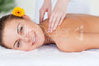 Close up of a beautiful woman having a shoulder massage