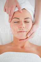Portrait of a woman enjoying a facial massage