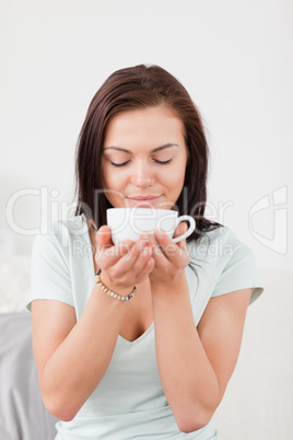 Portrait of a dark-haired woman drinking coffee