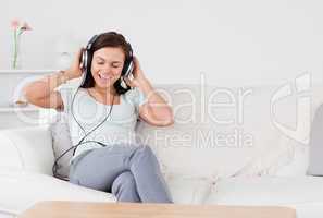 Smiling brunette listening to music