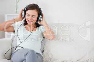 Charming brunette listening to music