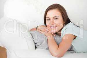 Close up of a cute woman lying on a sofa
