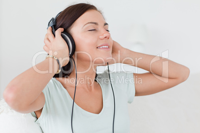 Charming brunette listening to music