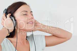 Close up of a charming brunette listening to music