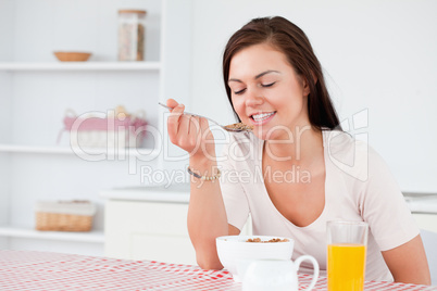 Charming woman eating cereal