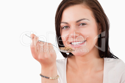 Close up of a smiling woman eating cereal