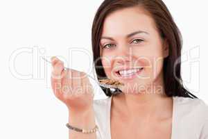 Close up of a smiling woman eating cereal
