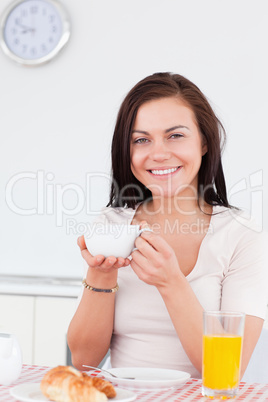 Beautiful brunette having her breakfast