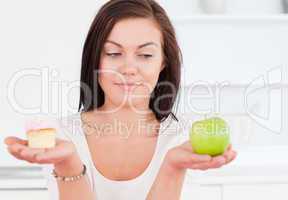 Cute woman with an apple and a piece of cake