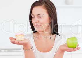 Charming woman with an apple and a piece of cake