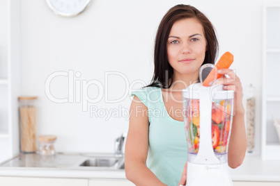 Beautiful woman using a blender