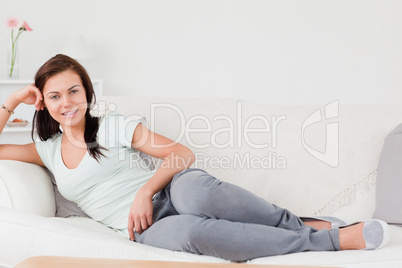 Cute woman lying on her sofa