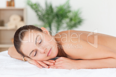 Close up of a woman lying on her belly closing her eyes