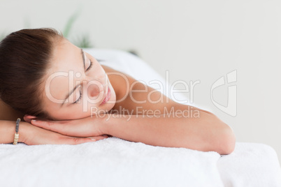 Close up of a cute brunette lying on a massage table