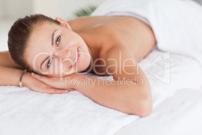 Close up of a dark-haired woman lying on a massage table