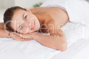 Close up of a dark-haired woman lying on a massage table