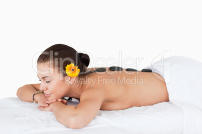 Young woman having a stone massage