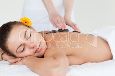 Close up of a woman enjoying a hot stone massage