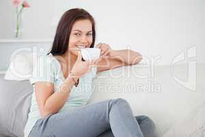 Cute brunette drinking tea