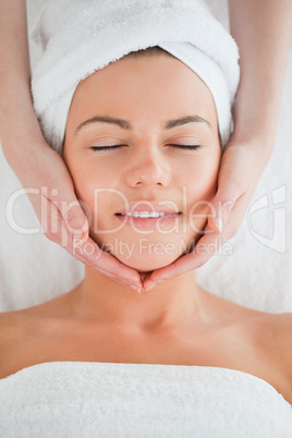 Portrait of a smiling woman having a facial massage