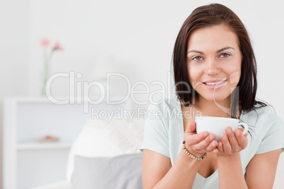 Beautiful dark-haired woman drinking tea