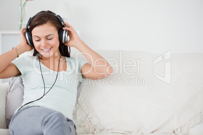 Smiling young woman listening to music