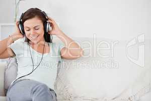 Smiling young woman listening to music