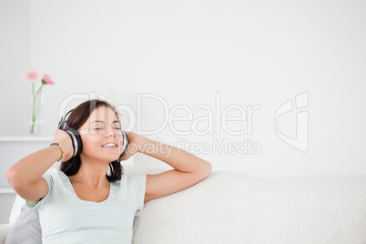 Delighted brunette listening to music