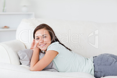 Charming woman lying on a sofa