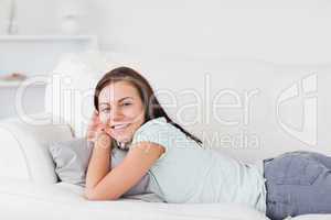 Charming woman lying on a sofa