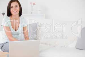 Young woman typing on her laptop