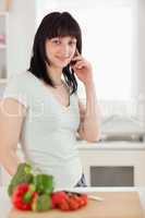 Beautiful brunette woman on the phone while standing