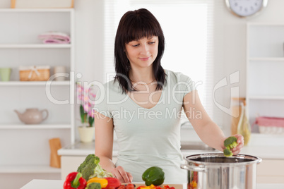 Attractive brunette woman cooking vegetables