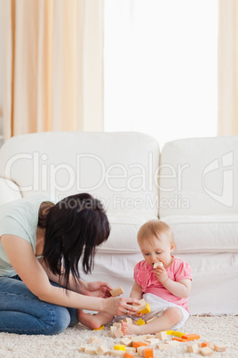 Beautiful woman playing with her baby in while sitting on a carp