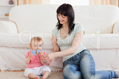 Attractive woman holding her baby in her arms while sitting on a