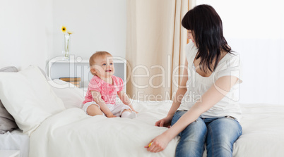 Attractive brunette woman enjoying a moment with her baby while