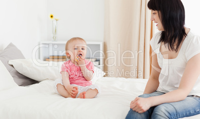 Good looking brunette woman enjoying a moment with her baby whil