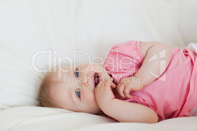 Lovely baby lying on a bed