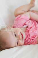 Cute blond baby lying on a bed