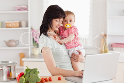 Charming woman holding her baby in her arms