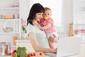 Charming woman holding her baby in her arms