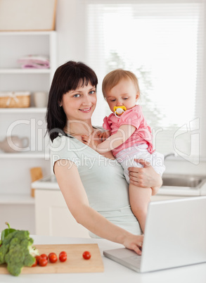 Cute woman holding her baby in her arms