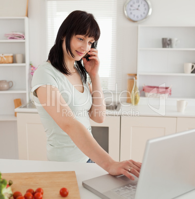 Good looking brunette female on the phone while relaxing with he