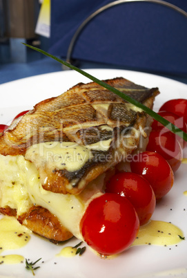 Fish with tomatoes and a potato