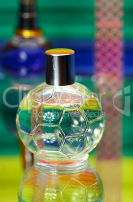 Glass bottles with perfumery. On a color background with reflect